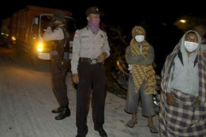 Agentes de policía ayudan en las labores de evacuación tras la erupción del volcán Merapi.