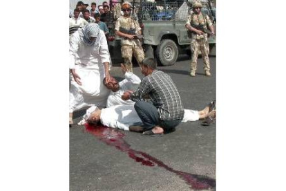 Dos soldados contemplan el asesinato de un iraquí en Basora