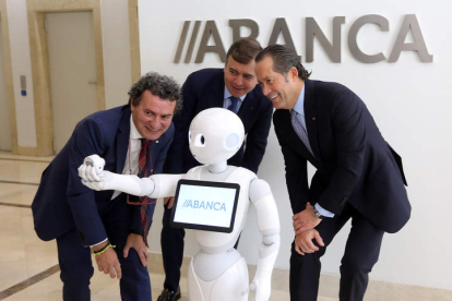 Un robot hace un ‘selfie’ al vicepresidente y al consejero delegado de Abanca (derecha). RAQUEL P. VIECO
