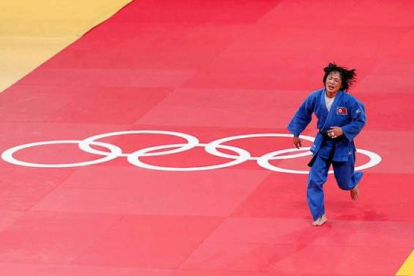 La norcoreana An Kum Ae corre celebrando su medalla de oro en la categoría de -52 kilos de judo después de vencer a la cubana Yanet. Foto: Bermoy REUTERS