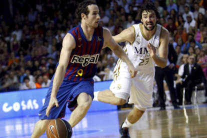 Huertas conduce el balón ante el jugador del Madrid Llul.