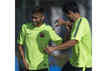 Neymar bromea con Luis Suárez durante el entrenamiento de ayer.