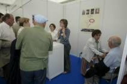 Personas mayores acuden a un puesto de un congreso de cardiología (2003) para tomarse la tensión