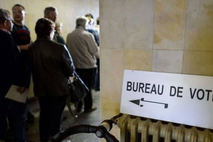 Ciudadanos suizos haciendo cola para votar en la localidad Bulle.