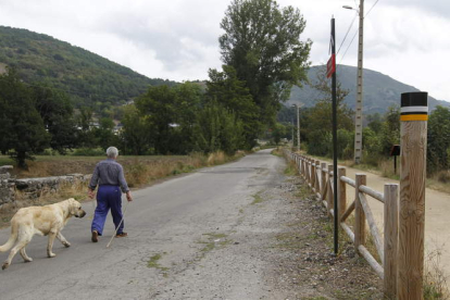 Un hombre camina con su perro por la Vía Verde de Laciana, en el Reserva de la Biosfera del Valle de Laciana. JESÚS F. SALVADORES