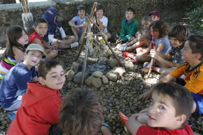 Varios de los niños que participan en las actividades de la fundación se sientan en torno a una hoguera, en uno de los talleres que realizaron ayer.