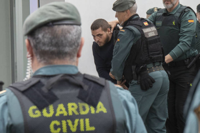 Agentes de la Guardia Civil trasladan a los juzgados de Barbate (Cádiz) a uno de los ocho detenidos por la muerte de dos guardias civiles a los que arrollaron con una narcolancha en la localidad gaditana de Barbate el pasado viernes, este lunes que han pasado a disposición judicial.