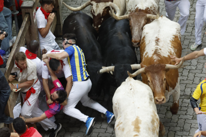 Mozos son perseguidos por toros de Victoriano del Río en el tercer encierro de los Sanfermines este martes, en Pamplona. EFE/Villar López