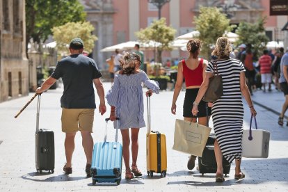 Una familia carga con sus maletas, en una fotografía de archivo. EFE/Manuel Bruque.
