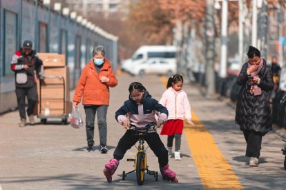 La gente camina frente al mercado de mariscos de Huanan, cerrado y vallado, en Wuhan, provincia de Hubei, China. EFE/ALEX PLAVEVSKI ATENCIÓN: Esta imagen es parte de un PHOTO SET