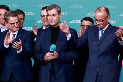 Friedrich Merz (d), presidente de la Unión Demócrata Cristiana (CDU) de Alemania, celebra ayer su triunfo.