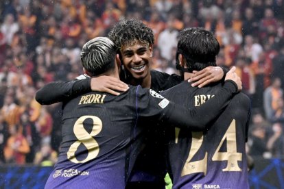 Lamine Yamal sonríe mientras abraza a Pedri y Eric en la celebración de uno de los goles.