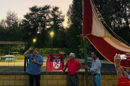 Gonzalo Fernández-Valladares, presidente de la Asociación Padre Isla, el poeta José Antonio Llamas y el pedáneo de Vidanes, Ricardo Rodríguez, con el pendón. MARISA VALBUENA RODRÍGUEZ