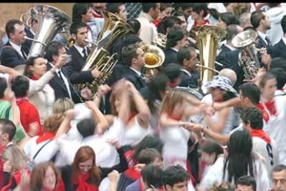 Apuros de un mozo que cae delante de uno de los toros de la ganadería gaditana de José Cebada Gago en el tramo del Ayuntamiento durante el segundo encierro de los Sanfermines 2005.