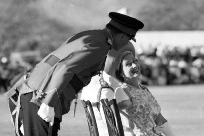 La reina Isabel II sonrie a un oficial del Regimiento Jamaicano durante una visita a Jamaica, en 1966. AP