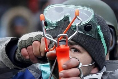 Un manifestante dispara a la policía con un tirachinas. REUTERS / VASILY FEDOSENKO