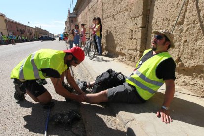 Minero mira el tobillo a otro durante la III Marcha Minera. NOBERTO