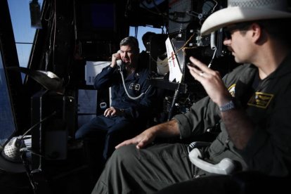 Un oficial se comunica con helicópteros MH-60 junto al teniente Arnold (airboss) (derecha) desde la torre de control de helicópteros como parte de la operación de recuperación de la cápsula Orión. CAROLINE BREHMAN