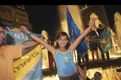 Una joven aficionada, eufórica, celebra el título que Alonso ha conseguido para España.