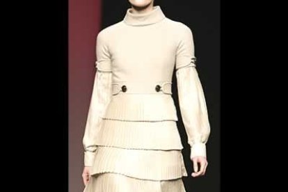 Los pantalones se presentan muy estrechos, tipo pitillo y siempre con tacones altísimos, y acompañados de largos blusones o vestidos sobre la rodilla que tuvieron especial importancia en una colección en la que el lazo fue un adorno fetiche en creaciones de apariencia sobria. En un desfile en negro, gris, azul turquesa, marrón y beige, destacó especialmente la línea confeccionada en amarillo, con un abrigo de cortes perfectos o el vestido de fiesta raso con topos negros, así como los plisados que coloca fila tras fila en las faldas, y los cortes con los que consigue que las prendas se ajusten plenamente al cuerpo.