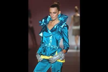 Bermudas y chaqueta turquesa con remates y cuello en satén , tejidos metalizados, vistosos y coloristas.