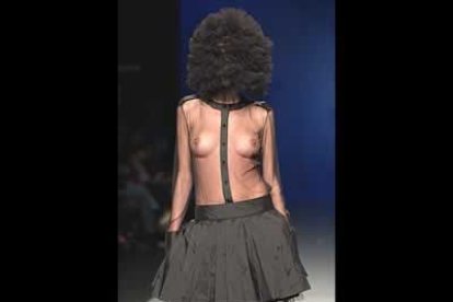 Falda de tafetán en seda negra y blusa transparente de gasa con tocado que cubre totalmente la cabeza. Es un diseño de David Delfín