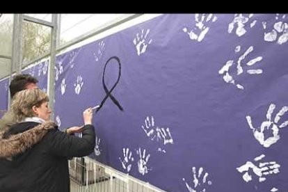 Las personas concentradas en las inmediaciones de Santa Eugenia han comenzado a estampar las palmas de la manos manchadas de blanco sobre lienzos negros colocados en unas vallas cercanas