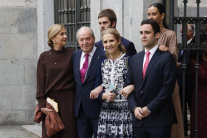 El rey emérito Juan Carlos I acompañado por sus hijas, las infantas Cristina (i) y Elena (2d) de Borbón, y sus nietos Felipe Juan Froilán de Marichalar (d), Victoria Federica de Marichalar (d, arriba) y Juan Valentín Urdangarín (c, detrás) posan a su salida de la boda del alcalde de Madrid, José Luis Martínez-Almeia, y Teresa Urquijo este sábado en la iglesia de San Francisco de Borja de Madrid.