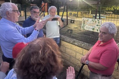 Los escritores Juan María Campal y Julio Llamazares hacen fotos a José Antonio Llamas ante la placa homenaje en el paseo del río, conocido como el sendero El Puerto. S.V.P.