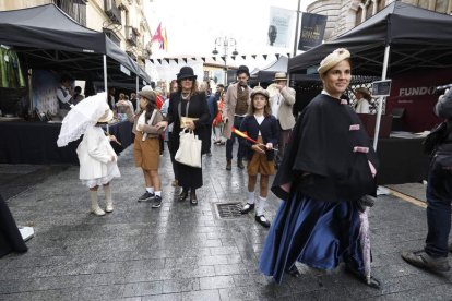 Una familia vestida de época posa para un retrato en el ‘photocall’ instalado en Ruiz de Salazar. El tren histórico a su llegada a Botines.  RAMIRO