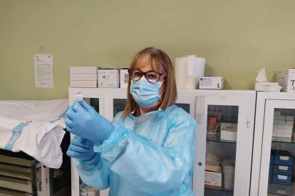 Con la mascarilla y preparada para vacunar en la