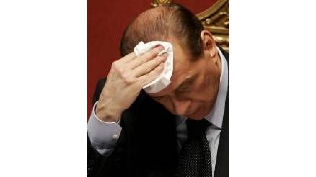 Berlusconi se seca la frente durante una sesión en el Senado italiano
