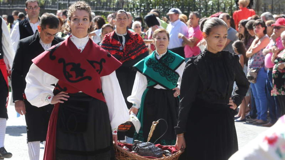 Jóvenes del municipio de Toreno portando en una cesta carbón como parte de la ofrenda de Toreno a la Virgen de la Encina