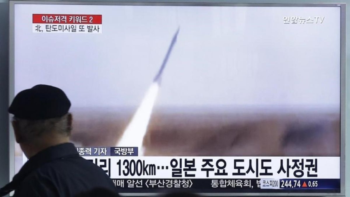 Un hombre sigue por televisión el lanzamiento del misil.
