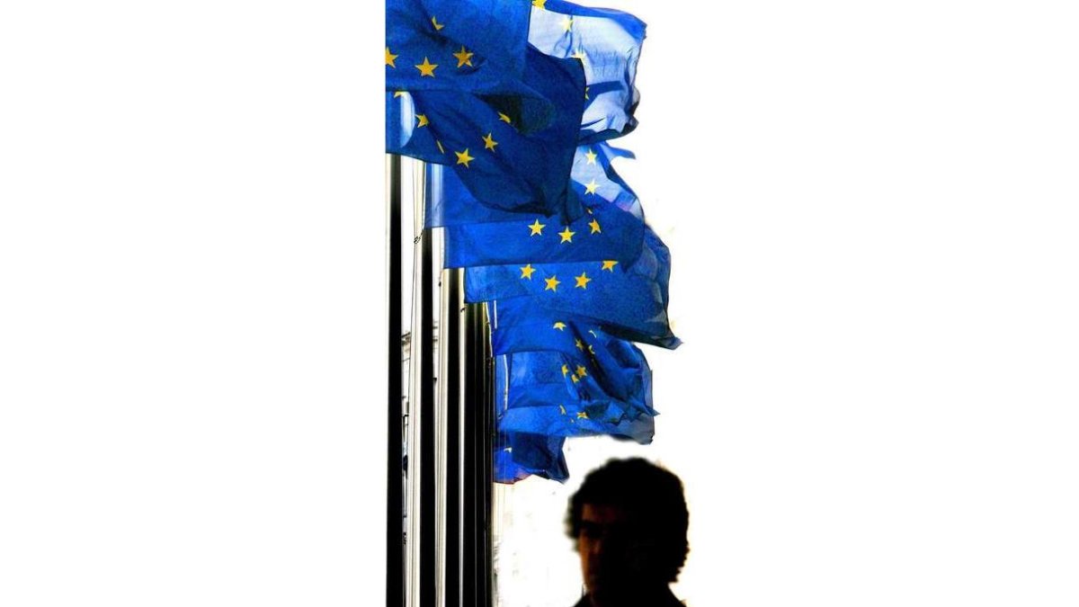 Un hombre pasa ante banderas de la UE en Bruselas. OLIVIER HOSLET