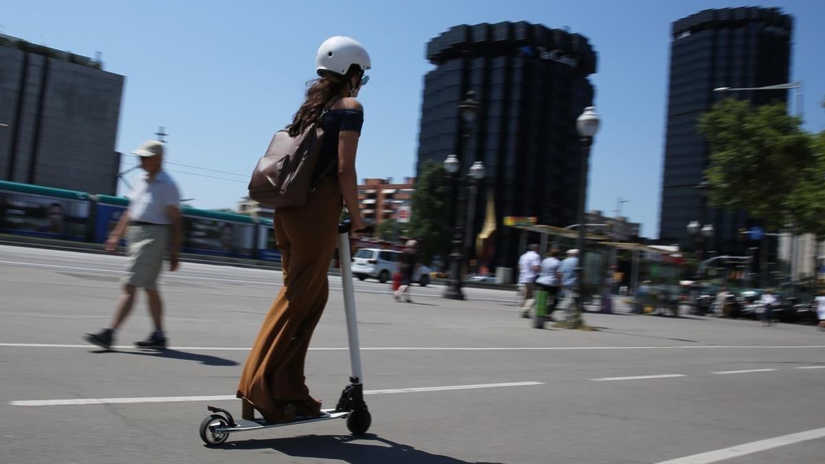 Una usuaria de patinete eléctrico, por la Diagonal, a la altura de Les Corts.