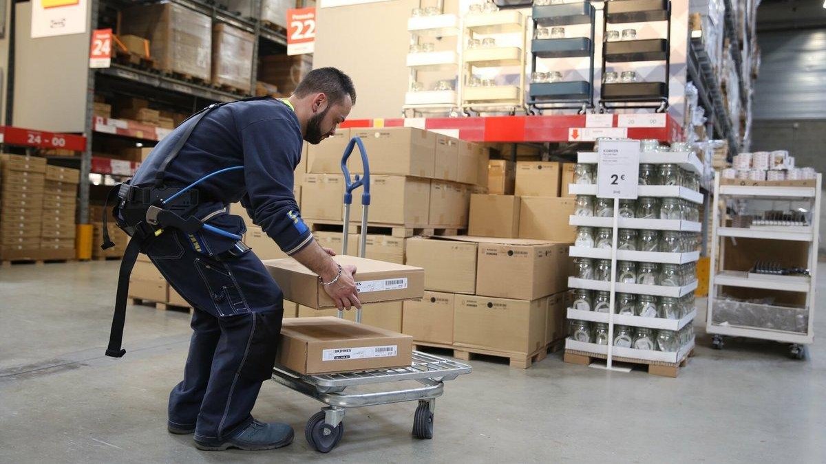 Borja, un empleado de Ikea en Badalona, lleva puesto un exoesqueleto para trabajar con facilidad y corregir errores.