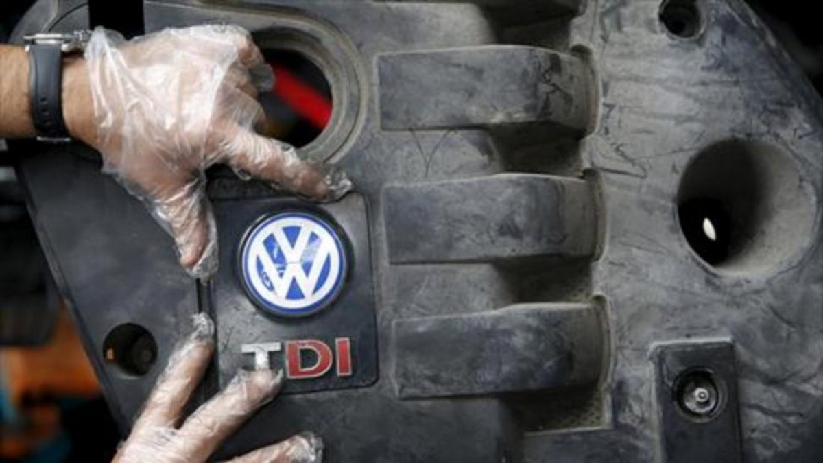 Un operario coloca la tapa de un motor diésel VW .