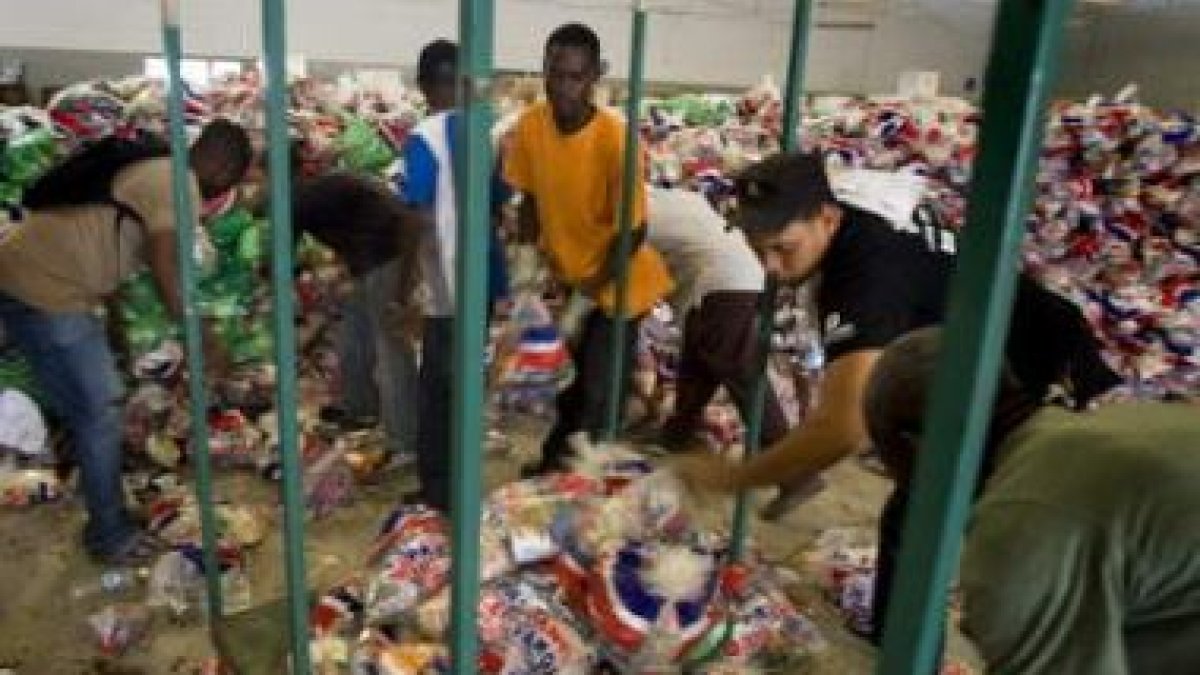 Miembros de la Misión de Estabilización de las Naciones Unidas en Haití reparten alimentos.
