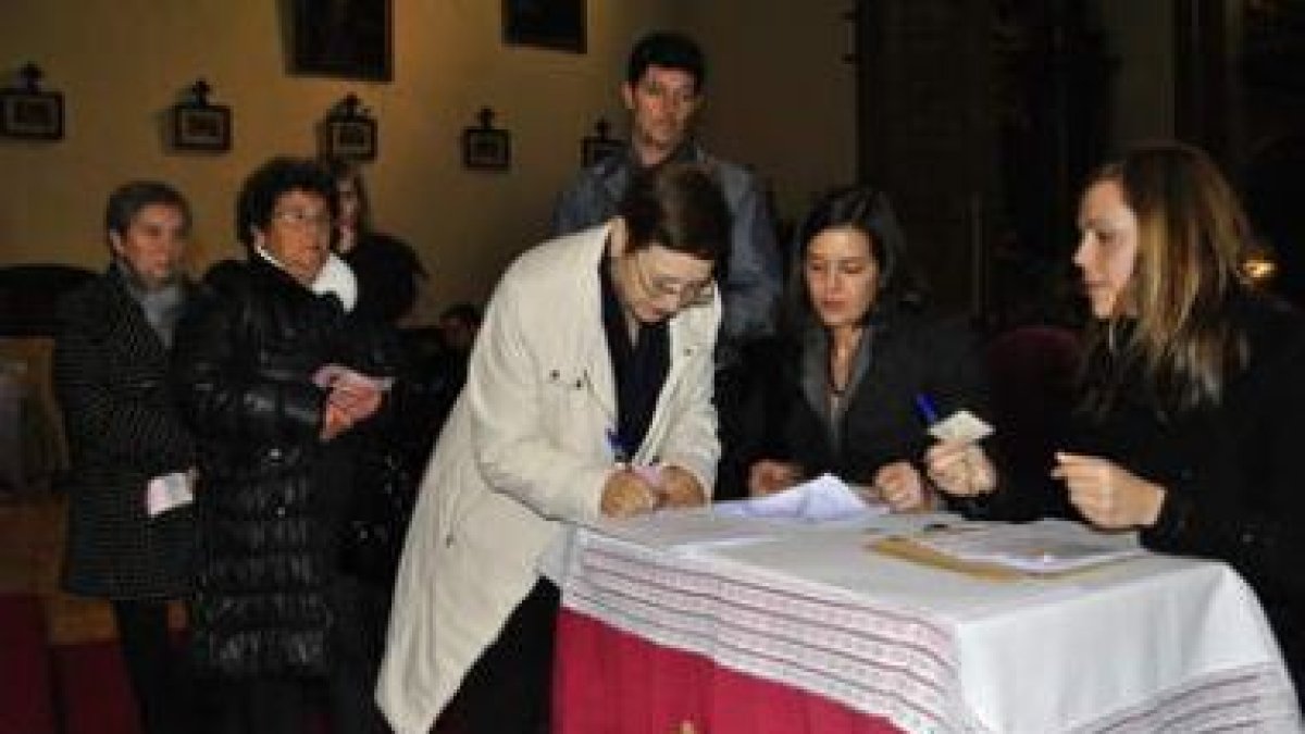 Una de las viudas recoge el cheque de la mutualidad, ayer en la Basílica de la Encina.
