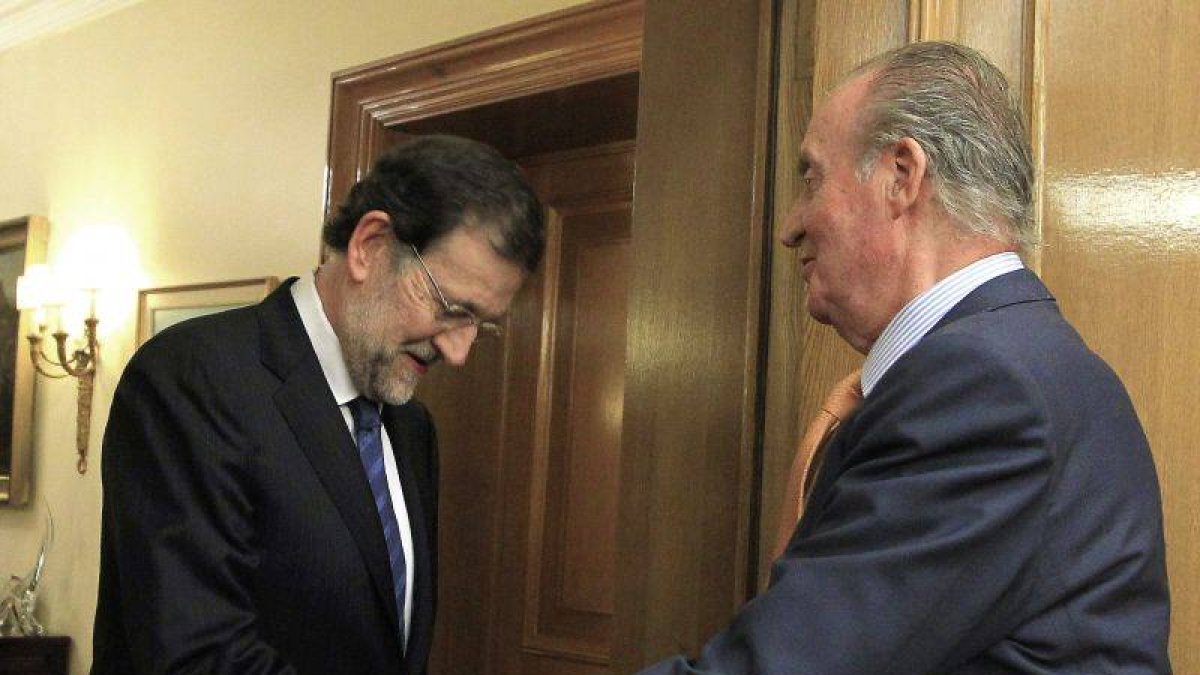 El rey Juan Carlos saluda al presidente del Partido Popular, Mariano Rajoy, a quien ha recibido en audiciencia en el Palacio de la Zarzuela, en la ronda de consultas del Jefe del Estado para la investidura del presidente del Gobierno.