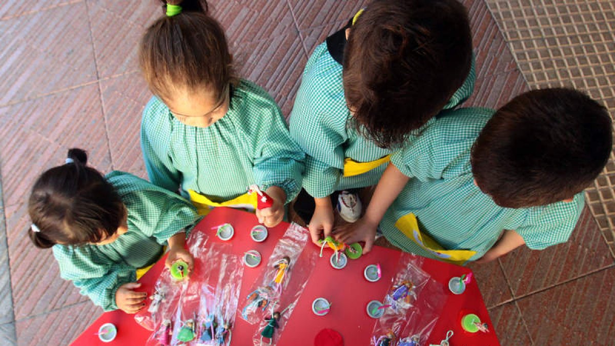 Varios niños y niñas del Hogar de la Esperanza juegan con algunos de los regalos que venderá la Escuela de Trabajo Social.