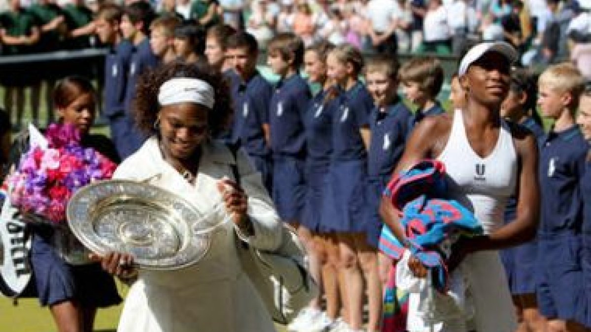 Serena Williams mira su trofeo tras vencer a su hermana.