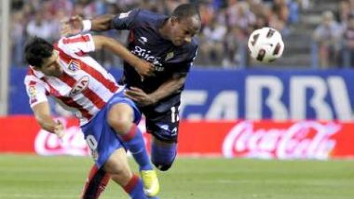 Agüero, a la izquierda, disputa un balón con el defensa francés Gregory del Sporting de Gijón.
