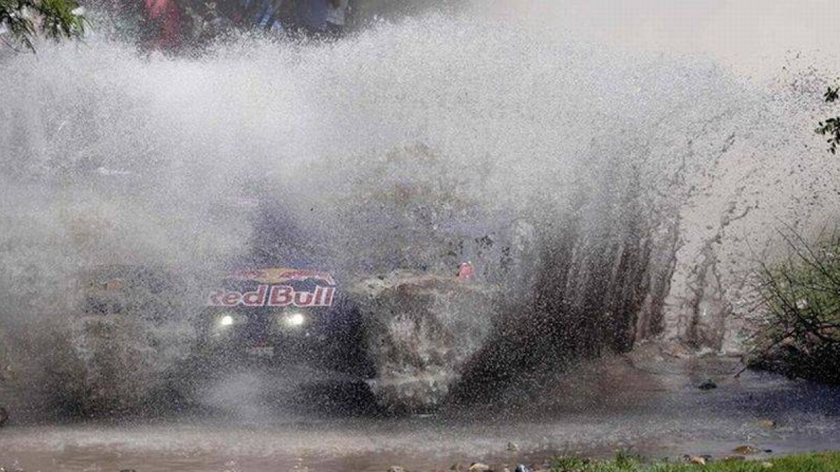 El piloto Carlos Sainz atraviesa un río en el rali Dakar.