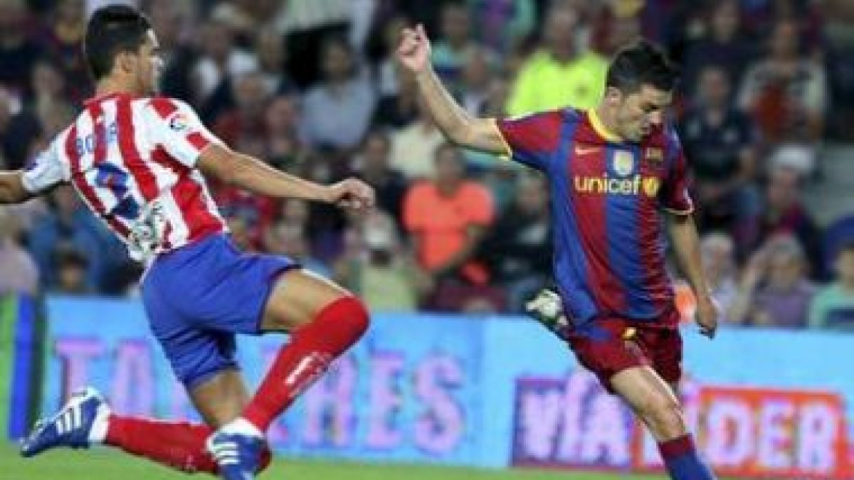 David Villa remata con su pierna izquierda ante el defensor sportinguista Botía.