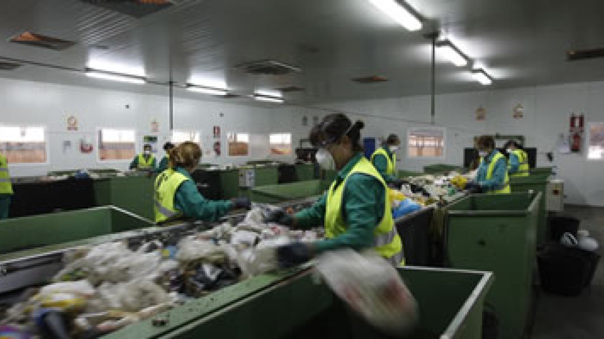 Trabajadores en el CTR de San Román de la Vega en la separación de residuos para su reciclaje.