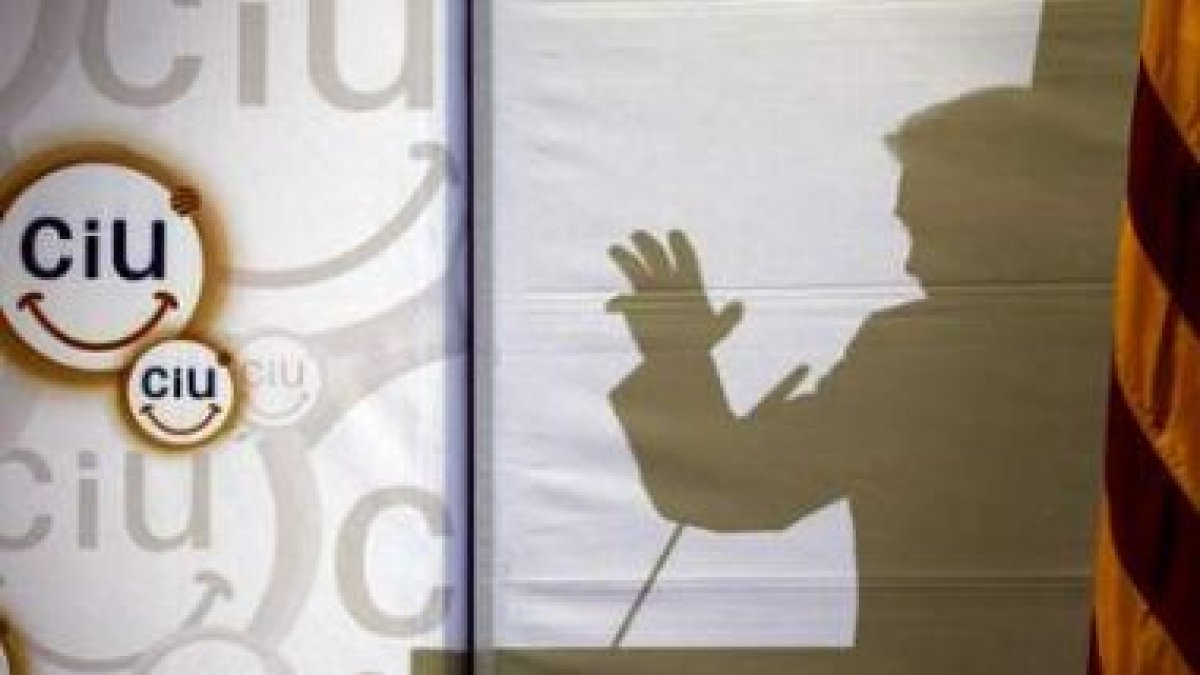La silueta del candidato de CiU, Artur Mas, reflejada en un panel durante un mitin.