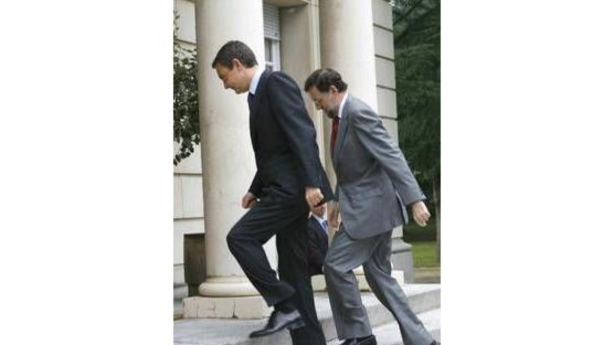 Zapatero y Rajoy suben las escaleras de la entrada a La Moncloa