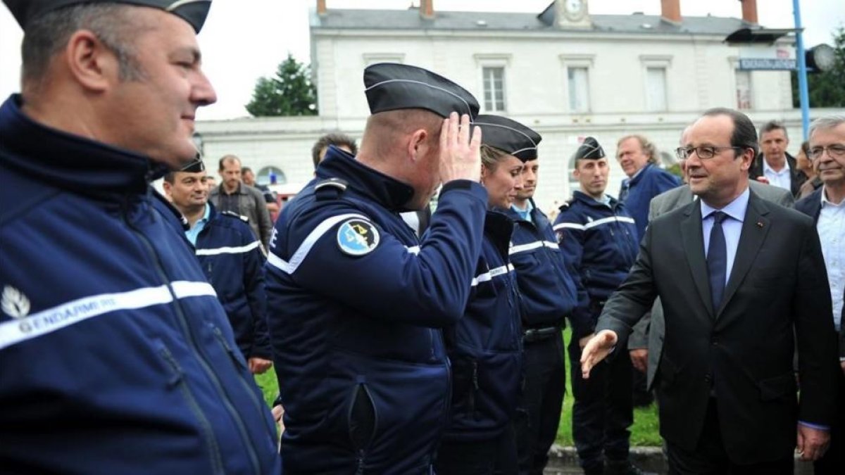 El presidente francés, François Hollande, saluda a varios gendarmes.